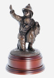 hand crafted 8" scale statuette of a Firefighter in the uniform of the 1970's era, wearing Siebe-Gorman breathing apparatus, protectively cradling a rescued infant. Handmade in bronze cold cast resin.