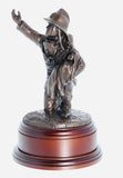 hand crafted 8" scale statuette of a Firefighter in the uniform of the 1970's era, wearing Siebe-Gorman breathing apparatus, protectively cradling a rescued infant. Handmade in bronze cold cast resin.