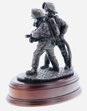 statuette is made in an eight inch scale and is called 'The Branch'. It depicts a pair of firefighters directing a high pressure jet of water at the seat of a blaze.