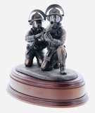 hand crafted 8" scale statuette of crouching Firefighters laying foam with a Branch.. Handmade in bronze cold cast resin.