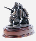 hand crafted 8" scale statuette of crouching Firefighters laying foam with a Branch.. Handmade in bronze cold cast resin.