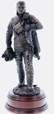 This statue is sculpted to show a firefighter having taken his helmet and BA mask off, worn out after fighting a fire.