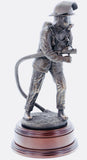 hand crafted 11" scale statuette of a Firefighter undertaking firefighting duties with a charged branch. Handmade in bronze cold cast resin.