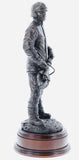 hand crafted 11" scale statuette of a Firefighter about to undertake rescue operations at a Road Traffic Collision (RTC). The 'Jaws of Life' is the nickname given by firefighters to large scale cutting & spreading equipment which is designed to release accident victims from their vehicles. These highly powerful tools are normally hydraulically charged and over the years, have saved thousands of lives. Handmade in bronze cold cast resin.