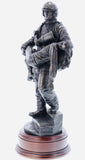 firefighter in the modern period carrying an unconscious victim from a burning building in a similar pose to that of the 'Saved' firefighter of Victorian Era painted by Charles Vigour which is displayed in the Fire Service Technical College at Moreton-in-Marsh.