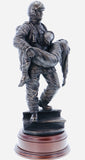 firefighter in the modern period carrying an unconscious victim from a burning building in a similar pose to that of the 'Saved' firefighter of Victorian Era painted by Charles Vigour which is displayed in the Fire Service Technical College at Moreton-in-Marsh.