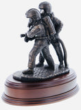 hand crafted 8" scale statuette of Firefighters tackling a fire on a branch wearing modern Cromwell F600 helmets. Handmade in bronze cold cast resin.