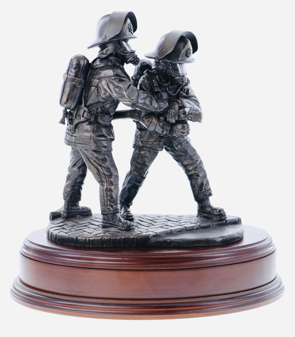 statuette is made in an eight inch scale and is called 'The Branch'. It depicts a pair of firefighters directing a high pressure jet of water at the seat of a blaze.
