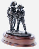 statuette is made in an eight inch scale and is called 'The Branch'. It depicts a pair of firefighters directing a high pressure jet of water at the seat of a blaze.