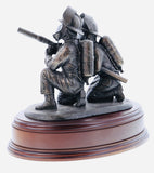hand crafted 8" scale statuette of crouching Firefighters laying foam with a Branch.. Handmade in bronze cold cast resin. 